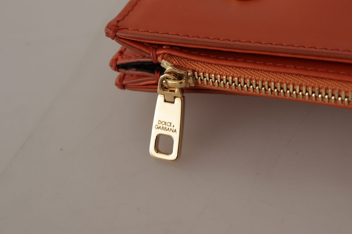 Exquisite Orange Leather Clutch with Gold Accents